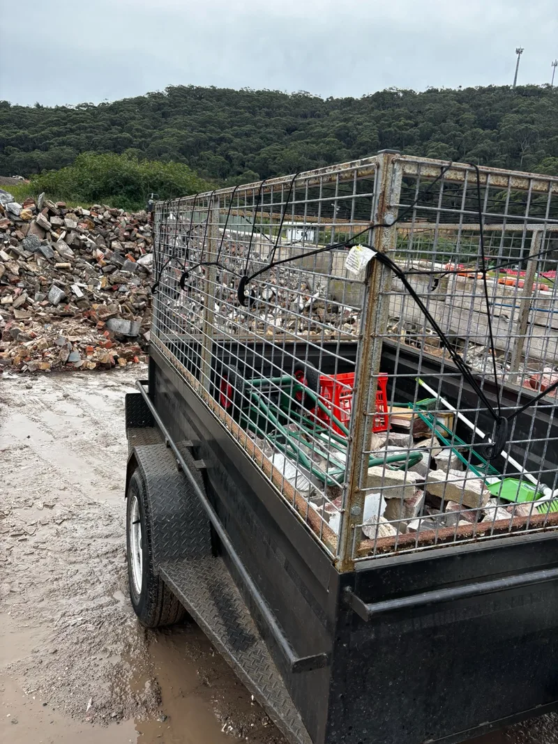 Trailer carrying brick rubble and demolition waste for disposal.