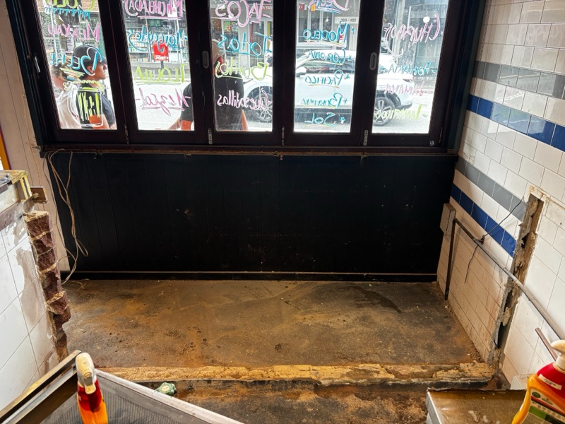 Wide view of the cleared commercial floor area after demolition.