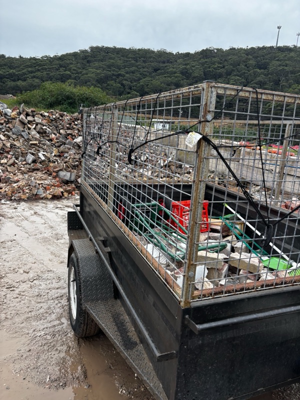 Trailer carrying brick rubble and demolition waste for disposal.