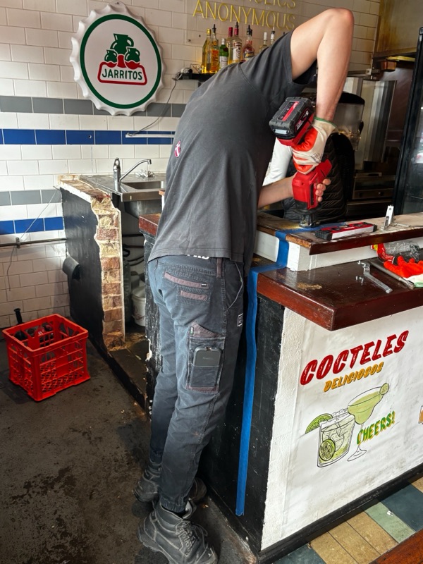 KPD Projects worker dismantling an existing commercial counter.