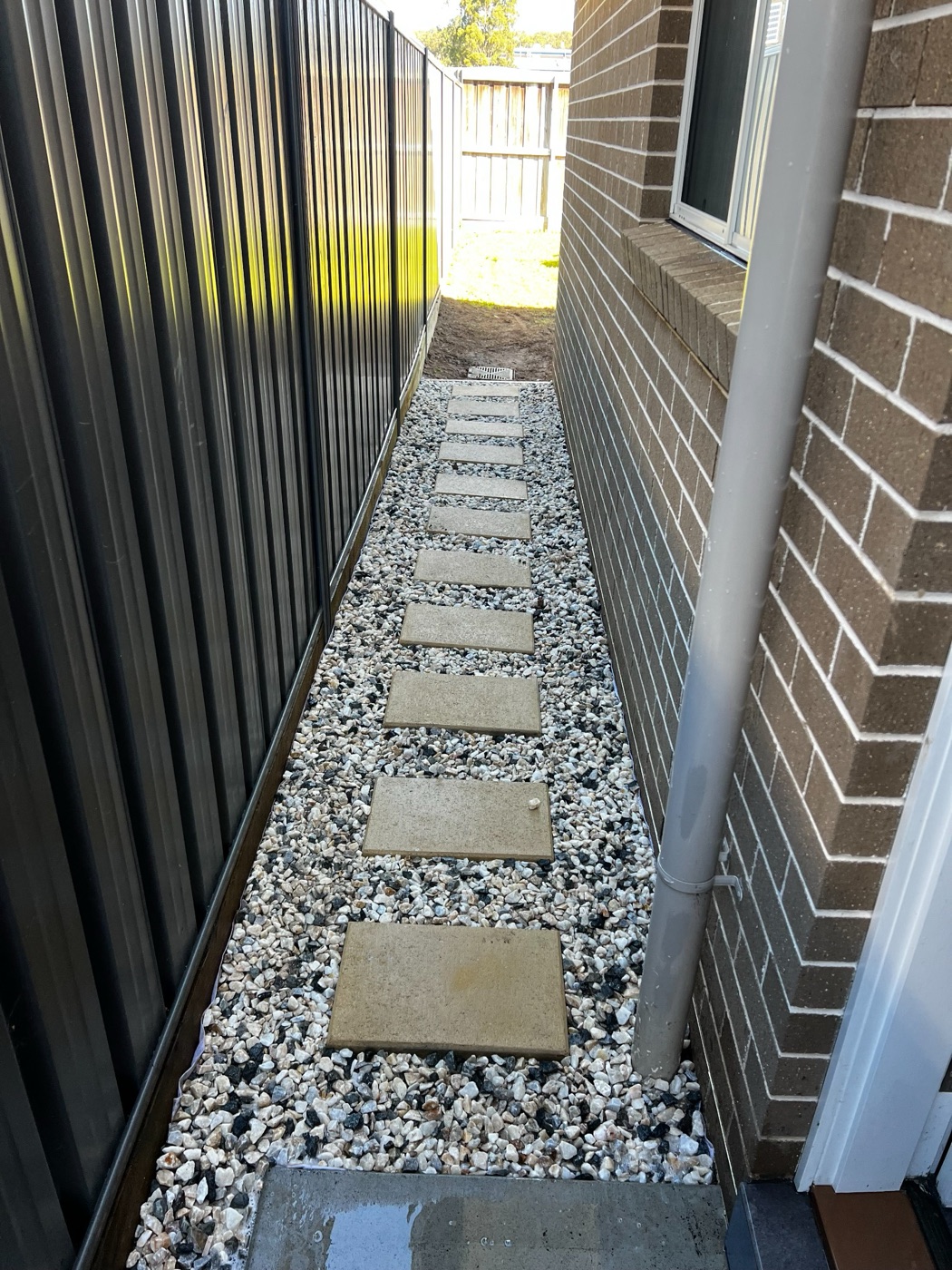 Finished stepping-stone path with decorative gravel beside a Gordon home.